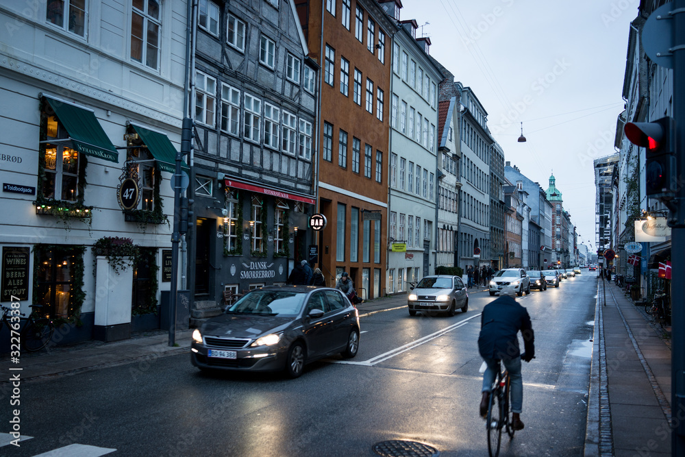 A car driving down an urban street